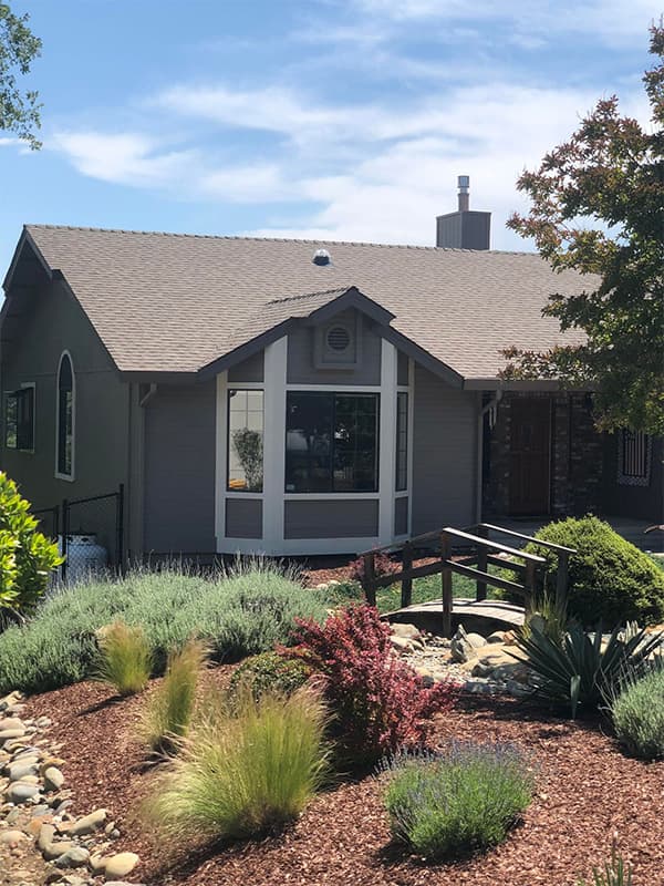 Slate-grey home with white trim showcasing professional exterior painting in El Dorado Hills, CA
