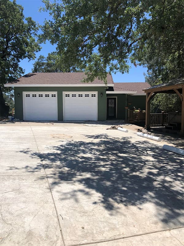 Green home with white trim showcasing professional exterior painting in El Dorado Hills, CA