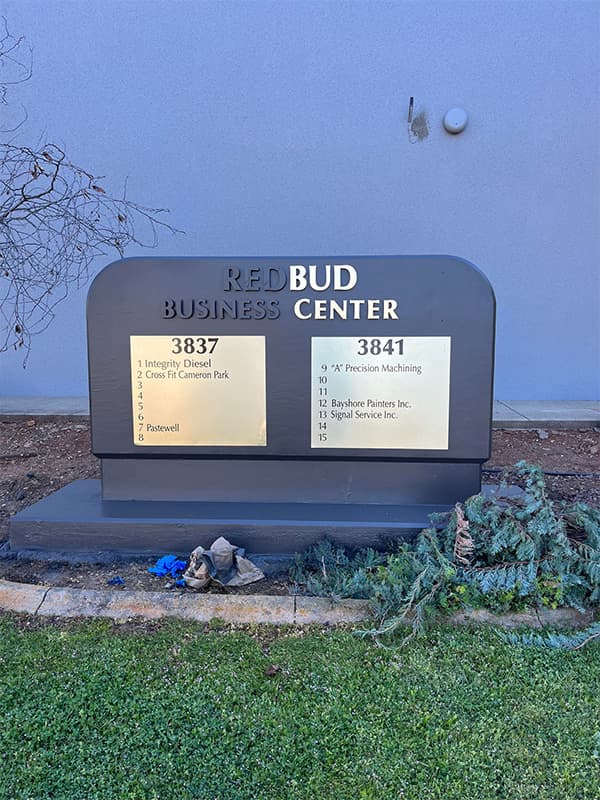 Business center plaque displayed in front of a freshly painted commercial building in El Dorado Hills, CA